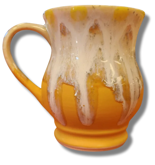 The same mug after the glaze firing, glossy yellow and white